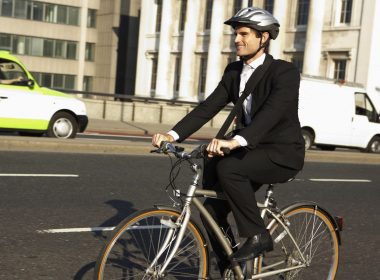 (Photo: a businessman riding a bicycle to work)